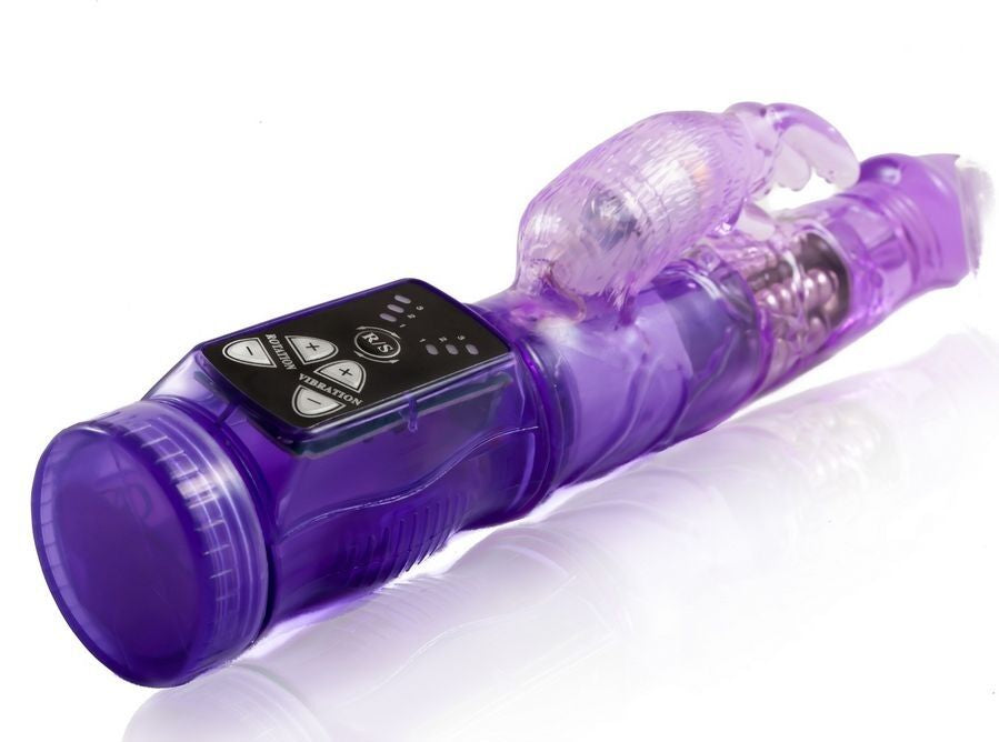 A purple, mini vibrator with a curved design and additional stimulator, featuring a transparent section showcasing internal mechanics. Enjoy 20 vibration modes with Baile Mini Happy Rabbit Vibrator. Soft gelatin, clitoral stimulator, waterproof. Ships UK & EU. Order now!