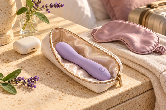 Compact lavender vibrator in a discreet travel pouch with a sleep mask and travel accessories