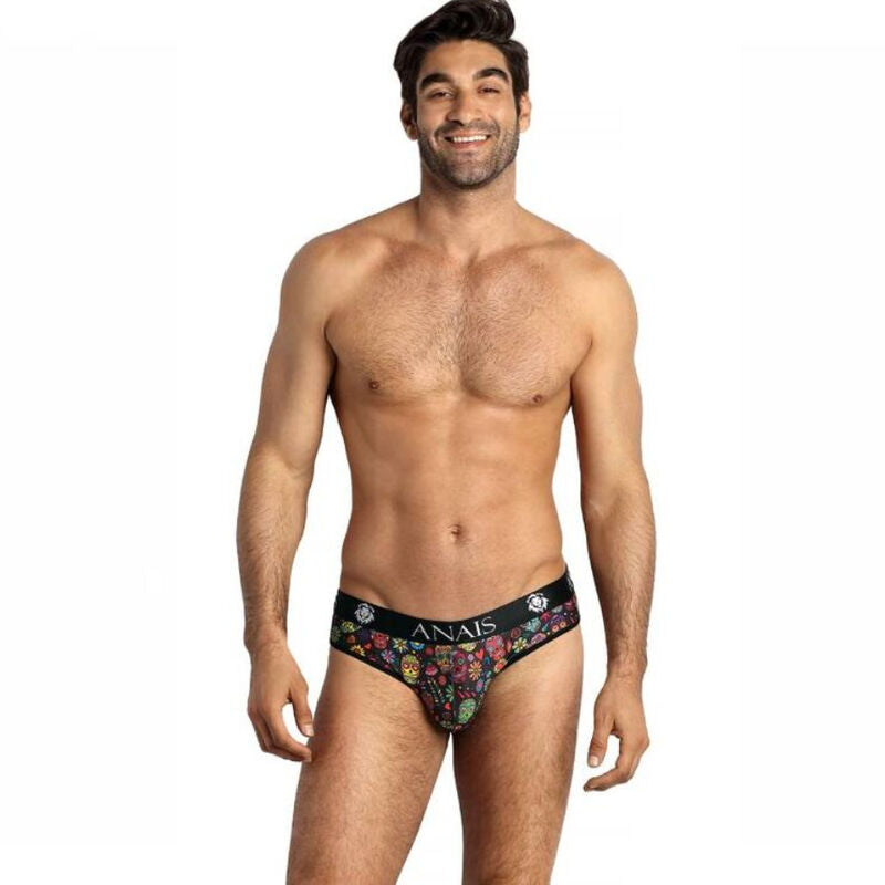 This image features a confident man modeling a colorful, patterned men's underwear by Anais. The underwear is designed with a blend of soft modal fabric and a playful print that includes small flowers and a skull, adding a touch of edginess and style.