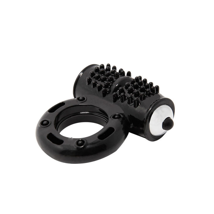 A black vibrating penis ring with a textured surface and a metallic ring at the base. The device appears to be compact and flexible.