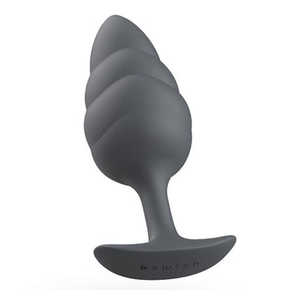 Experience new sensations with the B Swish Bfilled Butt Plug. Tapered tip, wave texture, body-safe silicone, and free-floating weight for ultimate pleasure.3